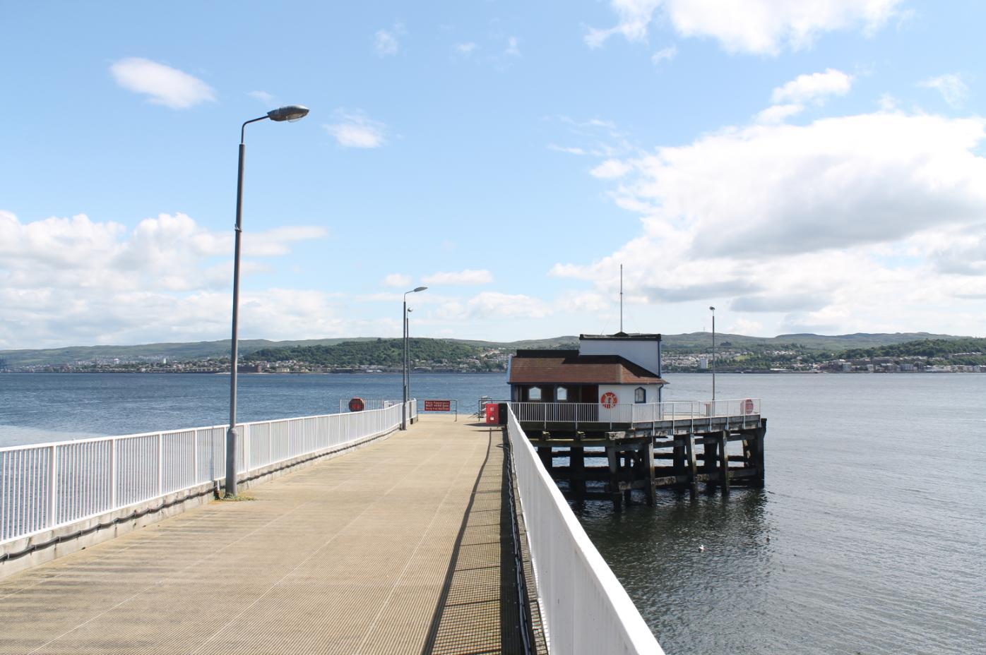 Image shows Kilcreggan Victorian Pier stretching out into the Firth of Clyde