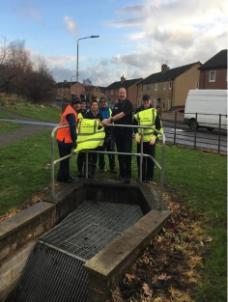 Group clearing a watercourse